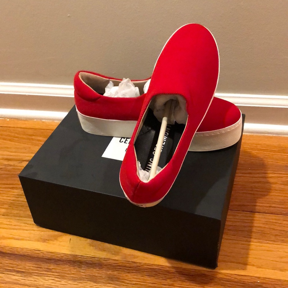 Opening ceremony red platform slip-ons.